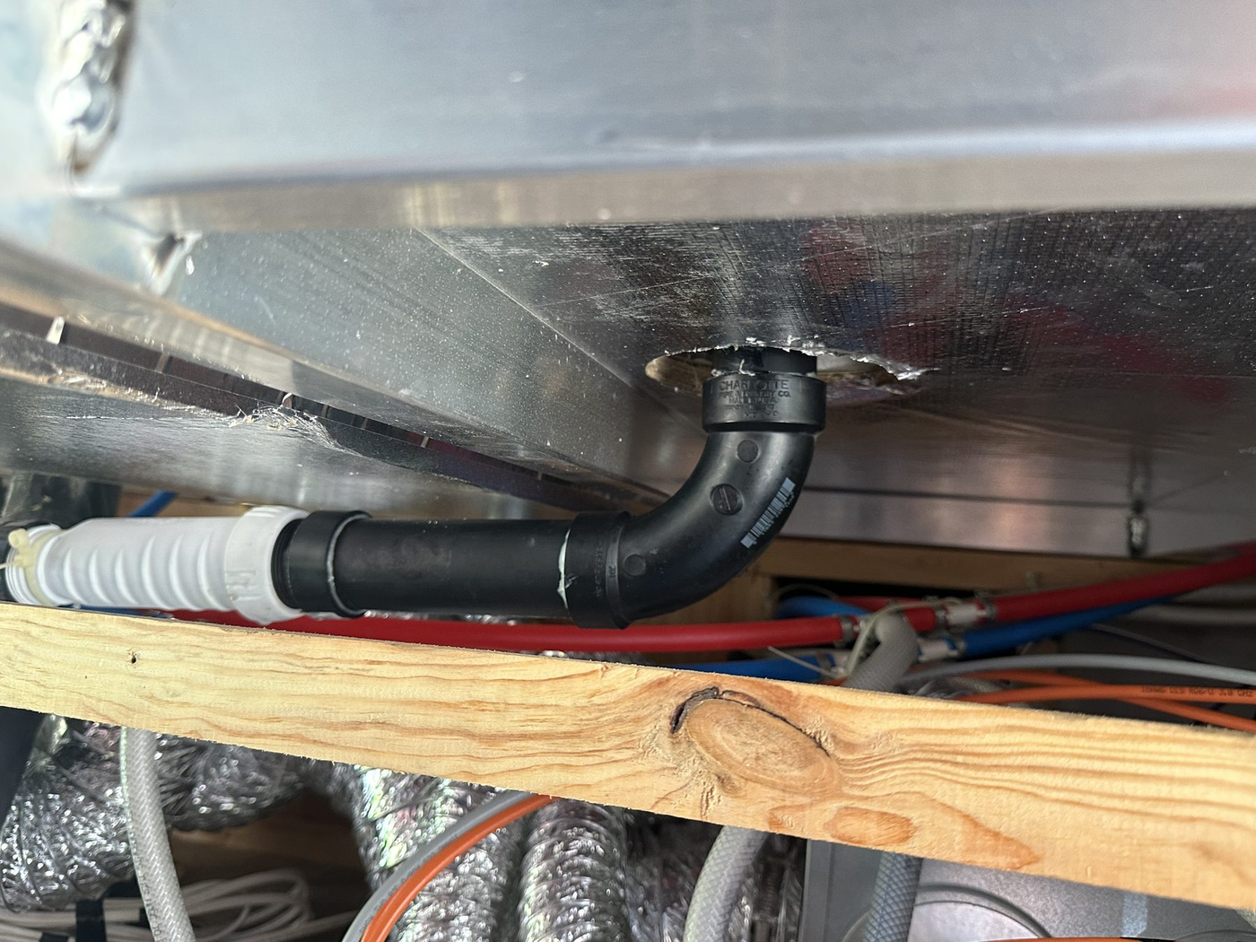 RV underbelly plumbing lines repaired below the floor