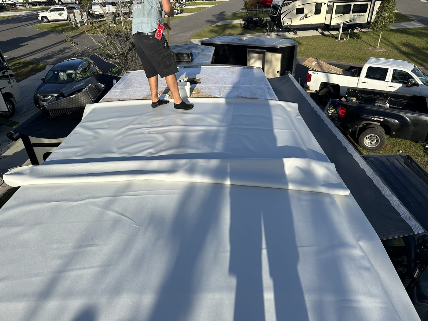 New white RV roof membrane over rebuilt roof decking